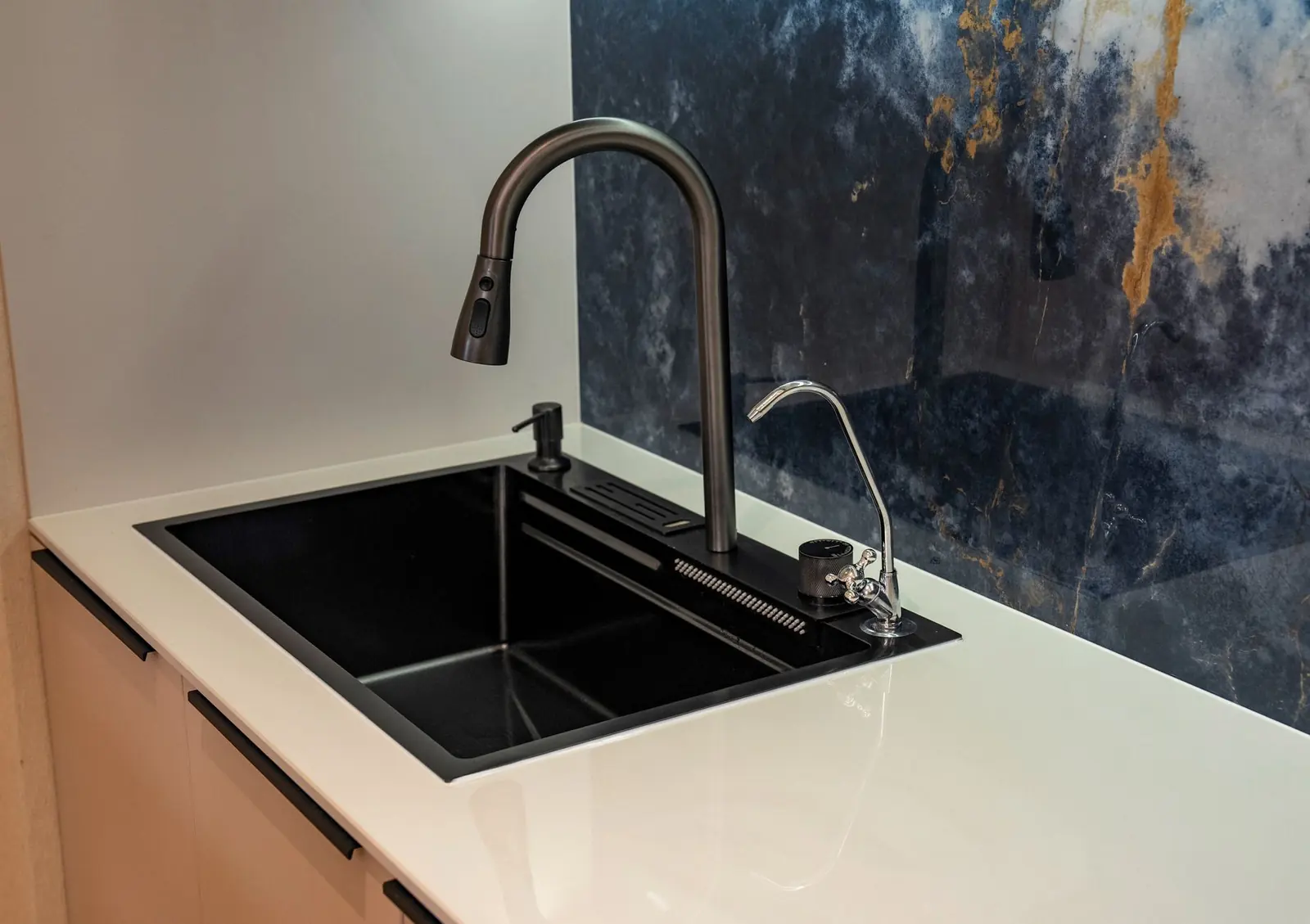 Dedicated reverse osmosis drinking water faucet beside a kitchen sink